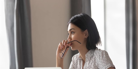 a worried woman using a laptop